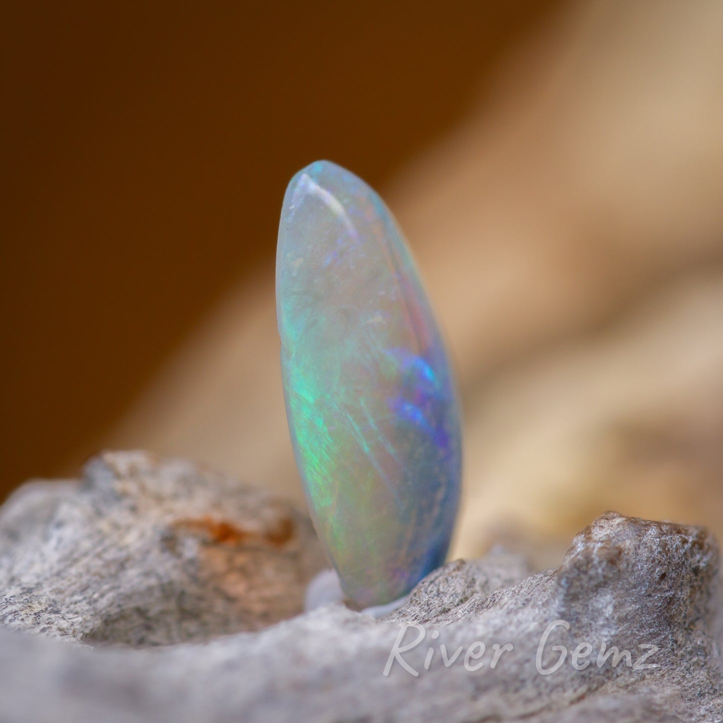 Side view of the opal showing flashes of blue in the predominantly green crystal opal.