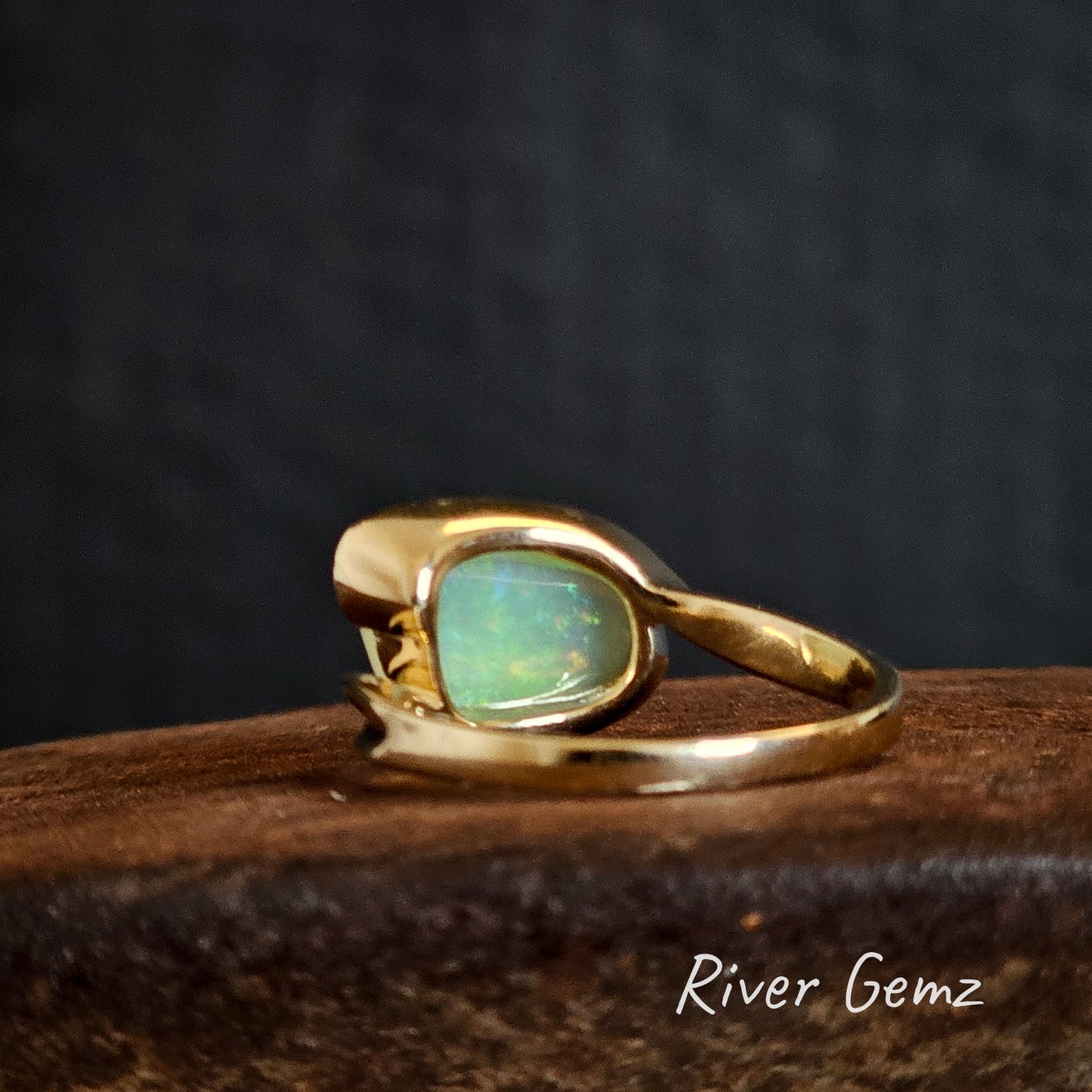 Back of the yellow gold ring shows the light base of the crystal opal.