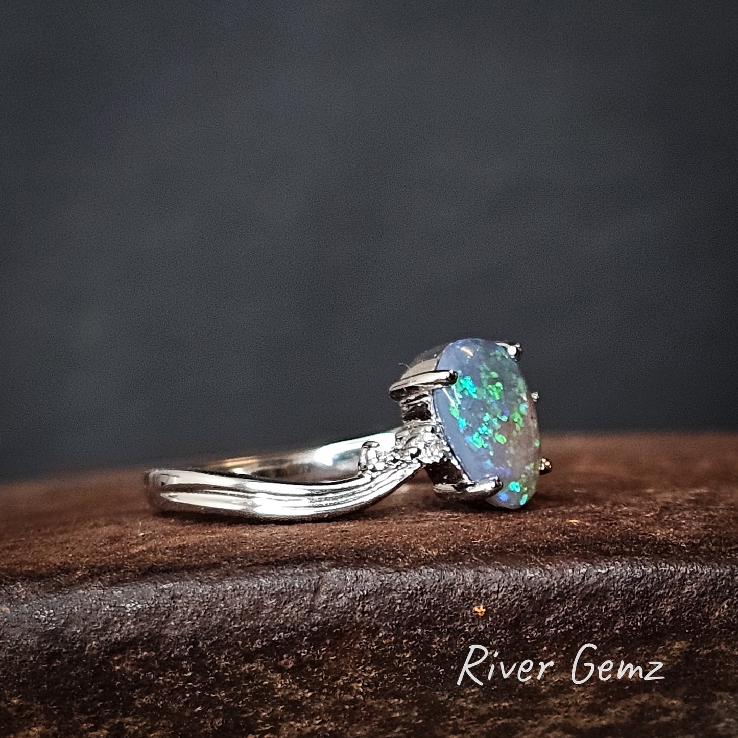 Side on view shows the wave in the shoulders of the white gold ring.