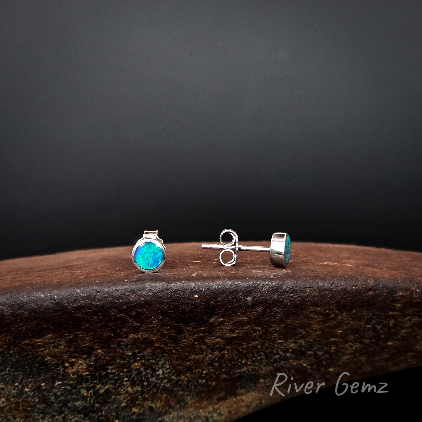 Front view of one earring and side view of the other to show the thickness of the opals set, the post length and the butterfly.