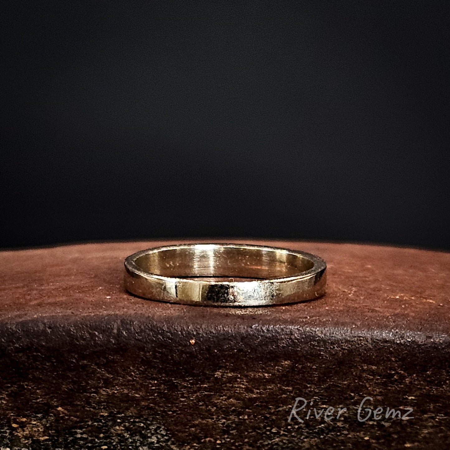 Rear view of the white gold ring showing the gold behind the opals on a dark surface with 'River Gemz' branding.