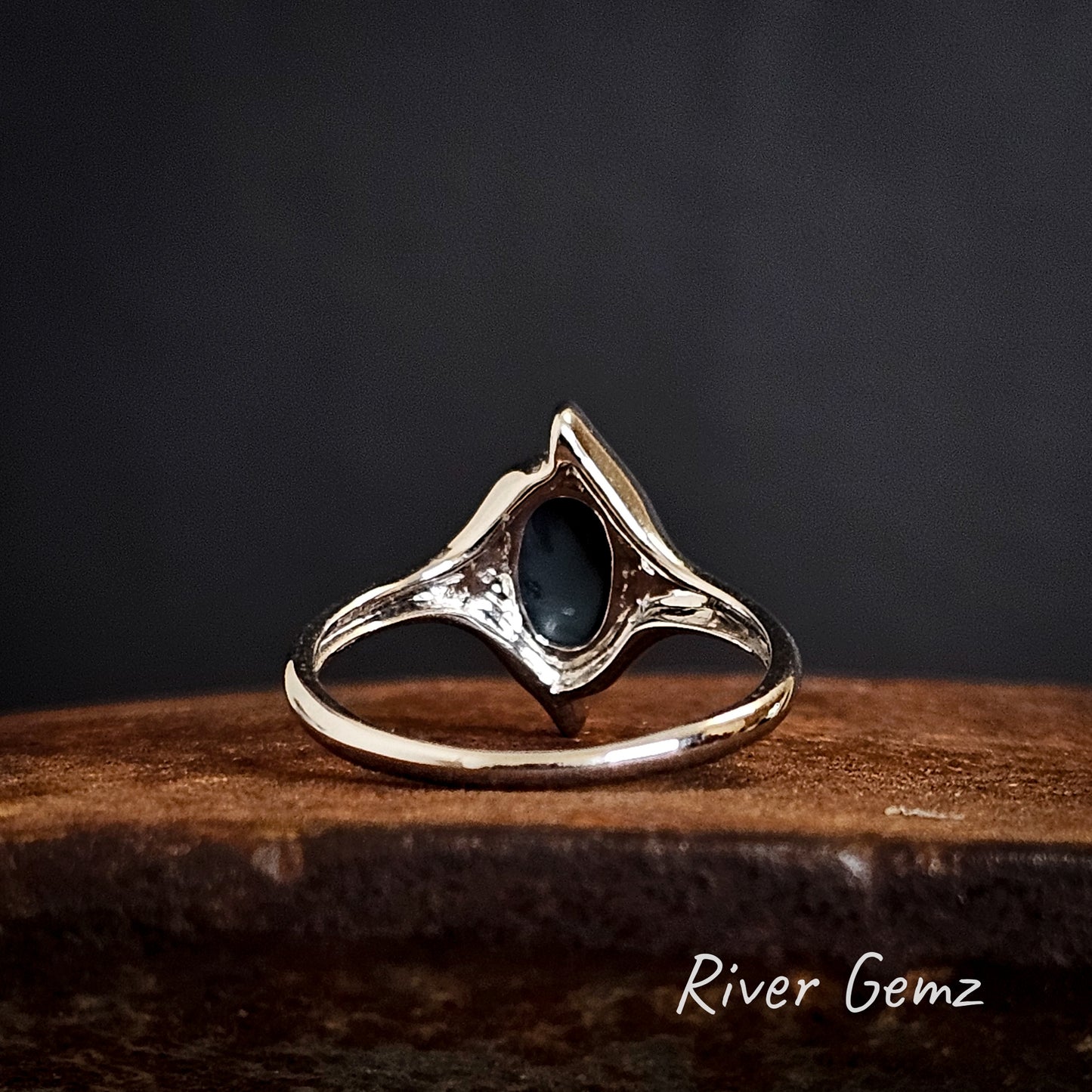 Rear of the ring shows the black base of the solid black opal set in the gold ring.