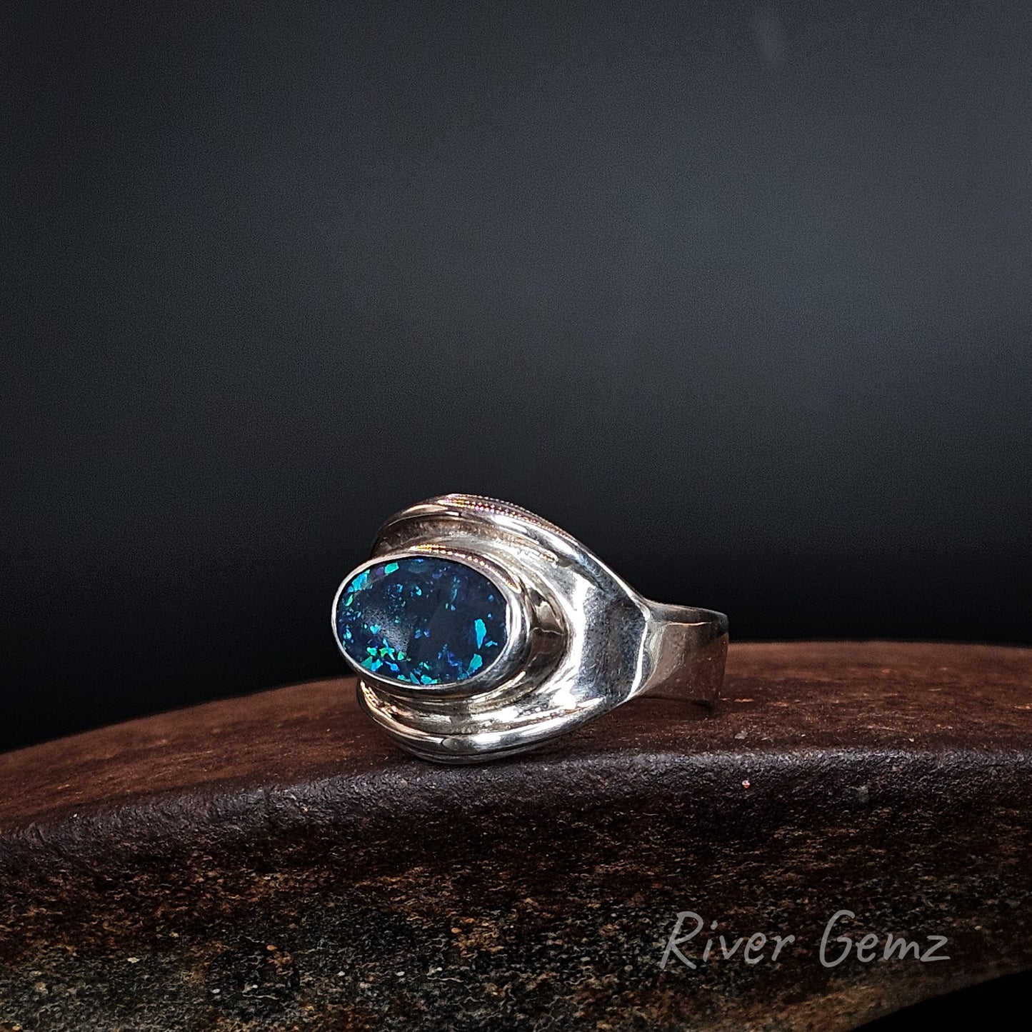 Blue and green black opal set in silver ring.