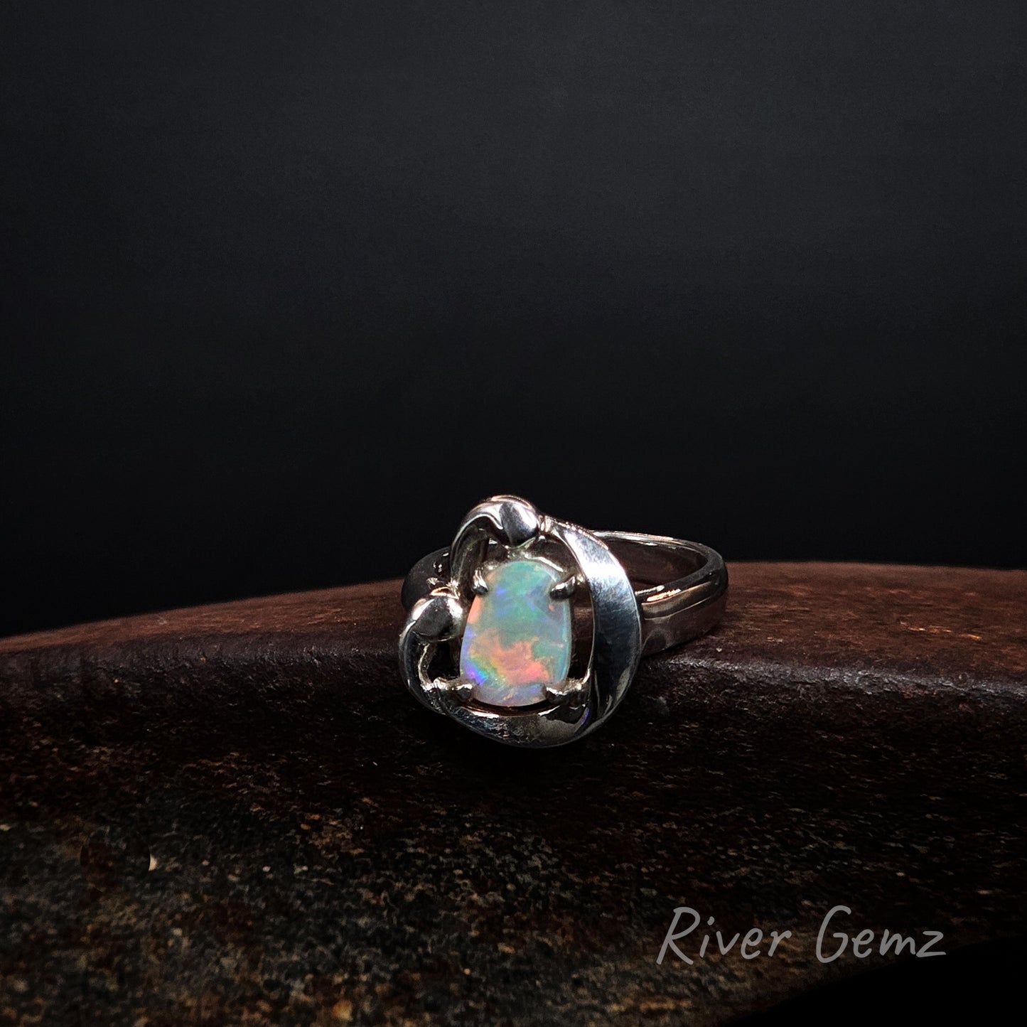 Light opal set in silver ring.