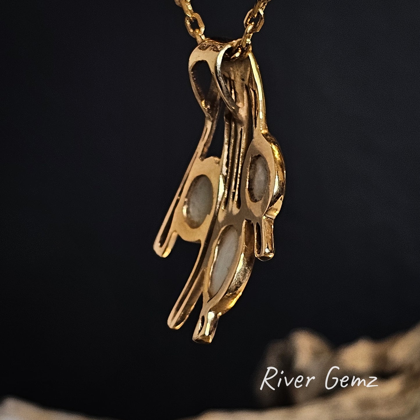 Rear view of the yellow gold necklace shows the light base of the crystal opals and the hidden bail.