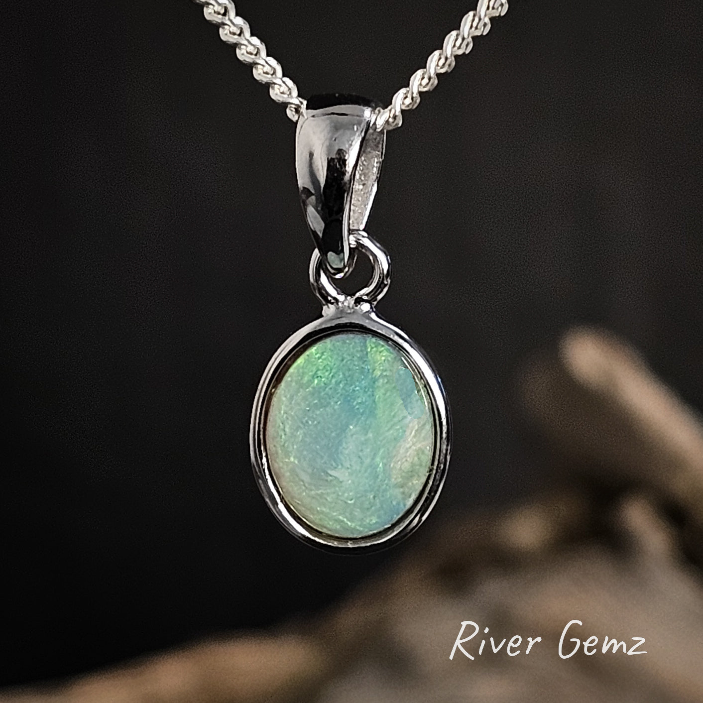 Opal pendant necklace with 'River Gemz' branding on a dark background