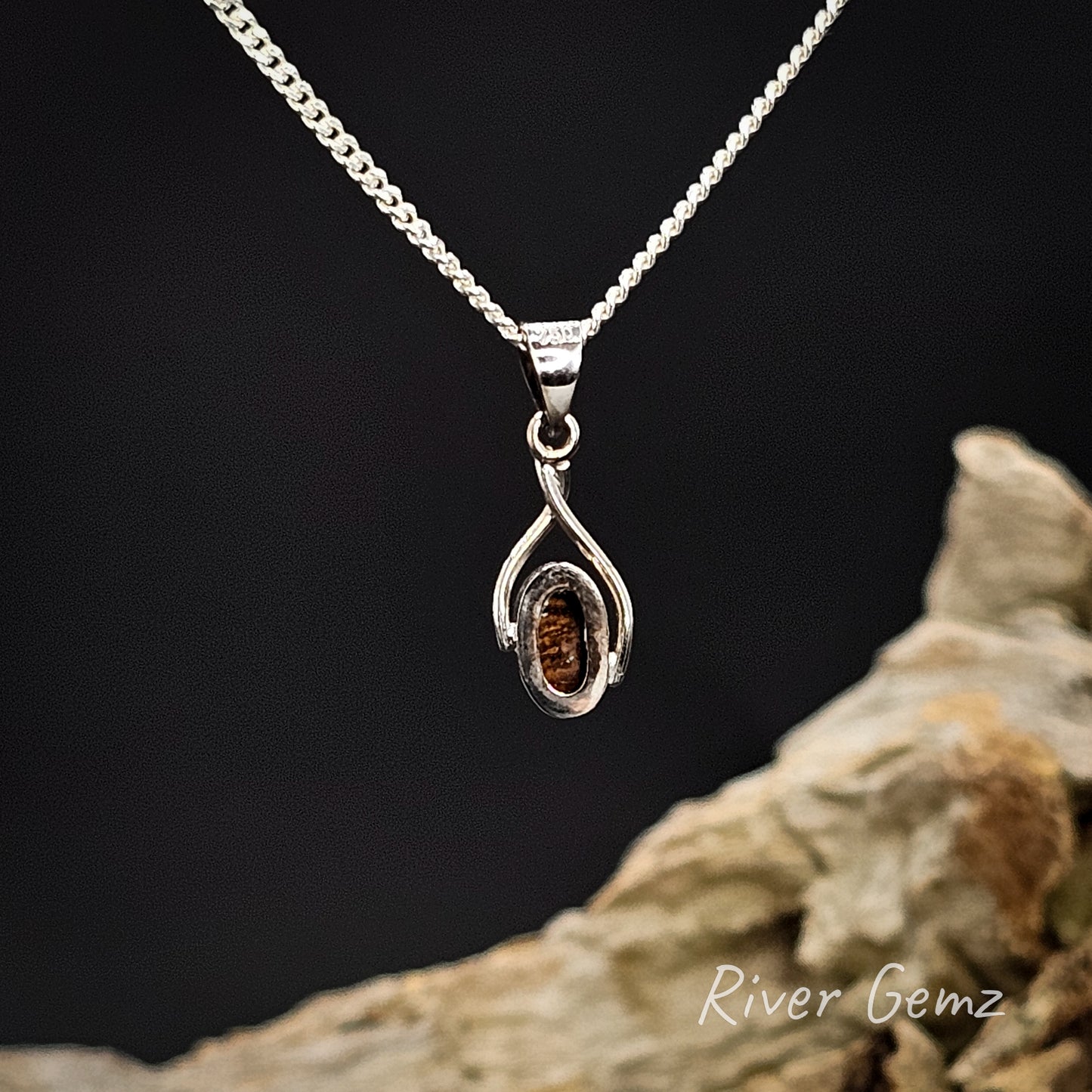 Rear view of the pendant showing the brown base tone of the boulder opal.
