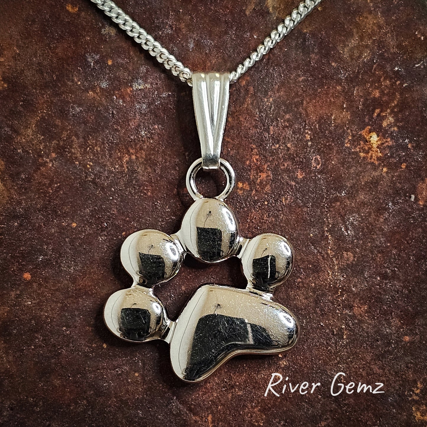 Second front on image of the solid silver pendant of a dog or cat paw print.