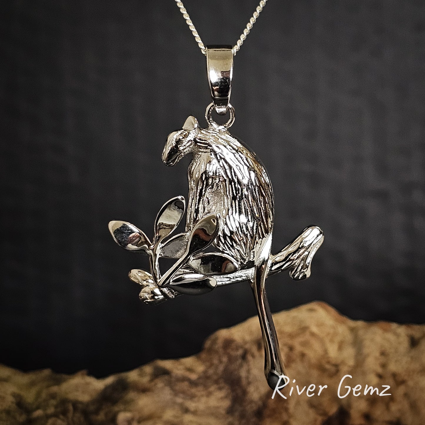 Silver tree kangaroo pendant on a chain against a dark background with 'River Gemz' branding.