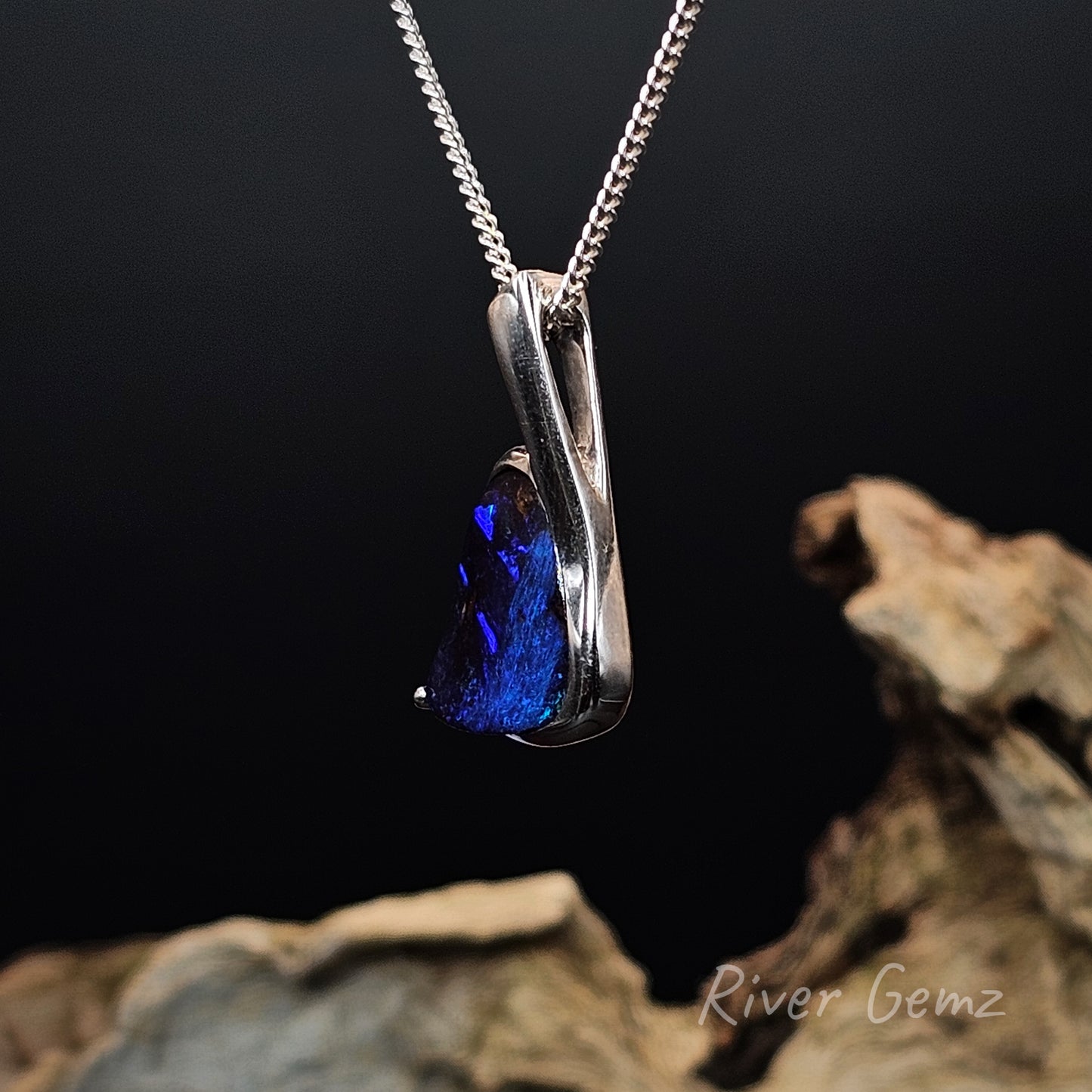 Side view of the silver pendant shows the large eyelet of the hidden bail.