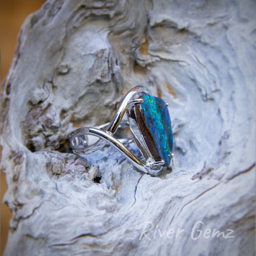 Side view of the ring shows the solid nature of the featured opal and the twist design of the shank.