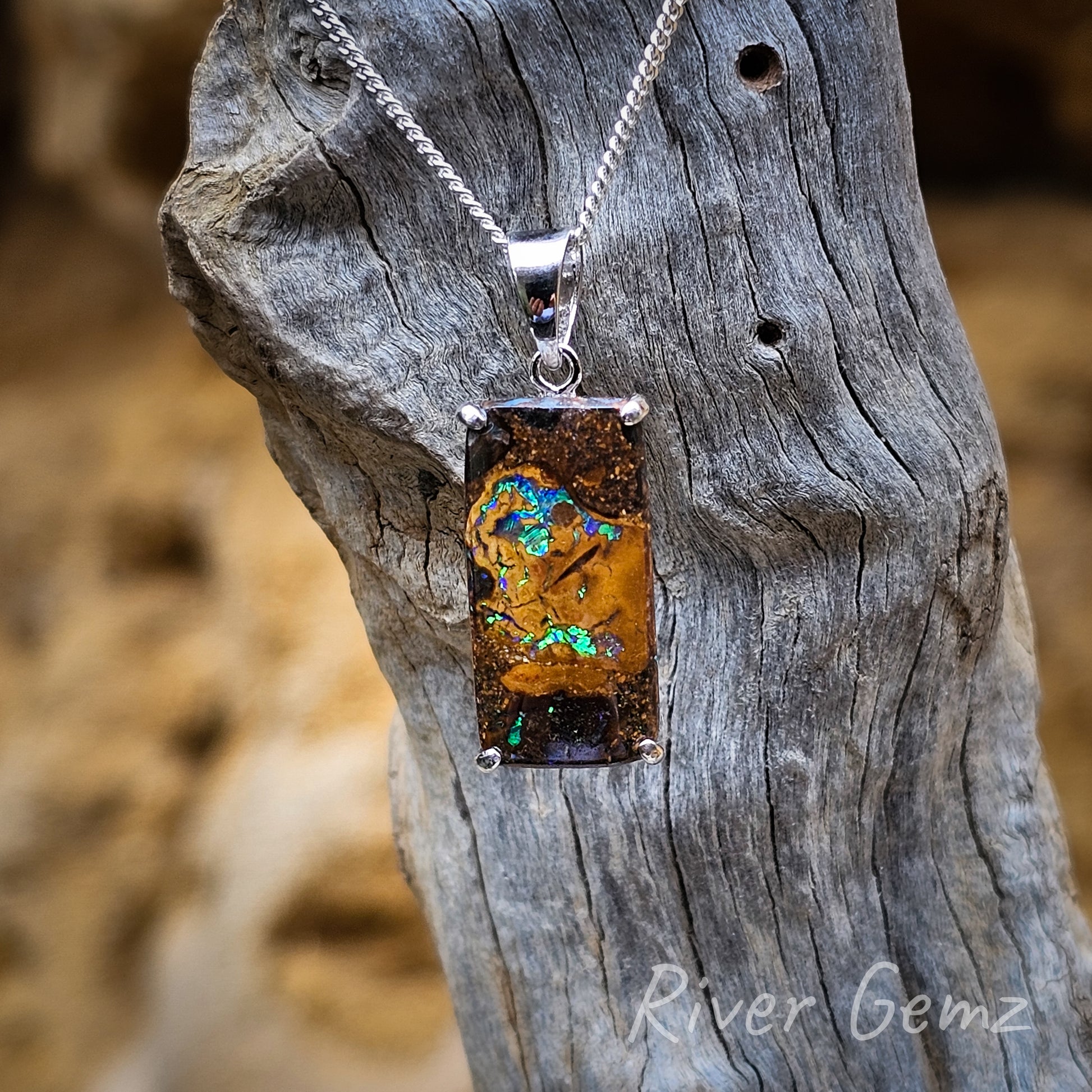 Rectangular shaped boulder matrix opal with two larger splashes of colour together with 6 smaller zones embedded in the ironstone host rock. Two definite shades of brown in this gem stone.