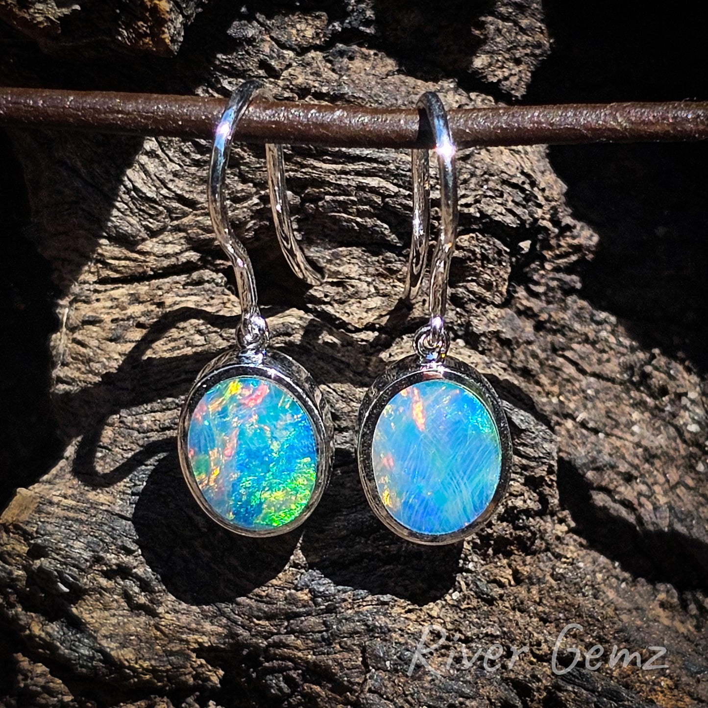 The oval shaped opals are almost half the entire height of the French hook earring.