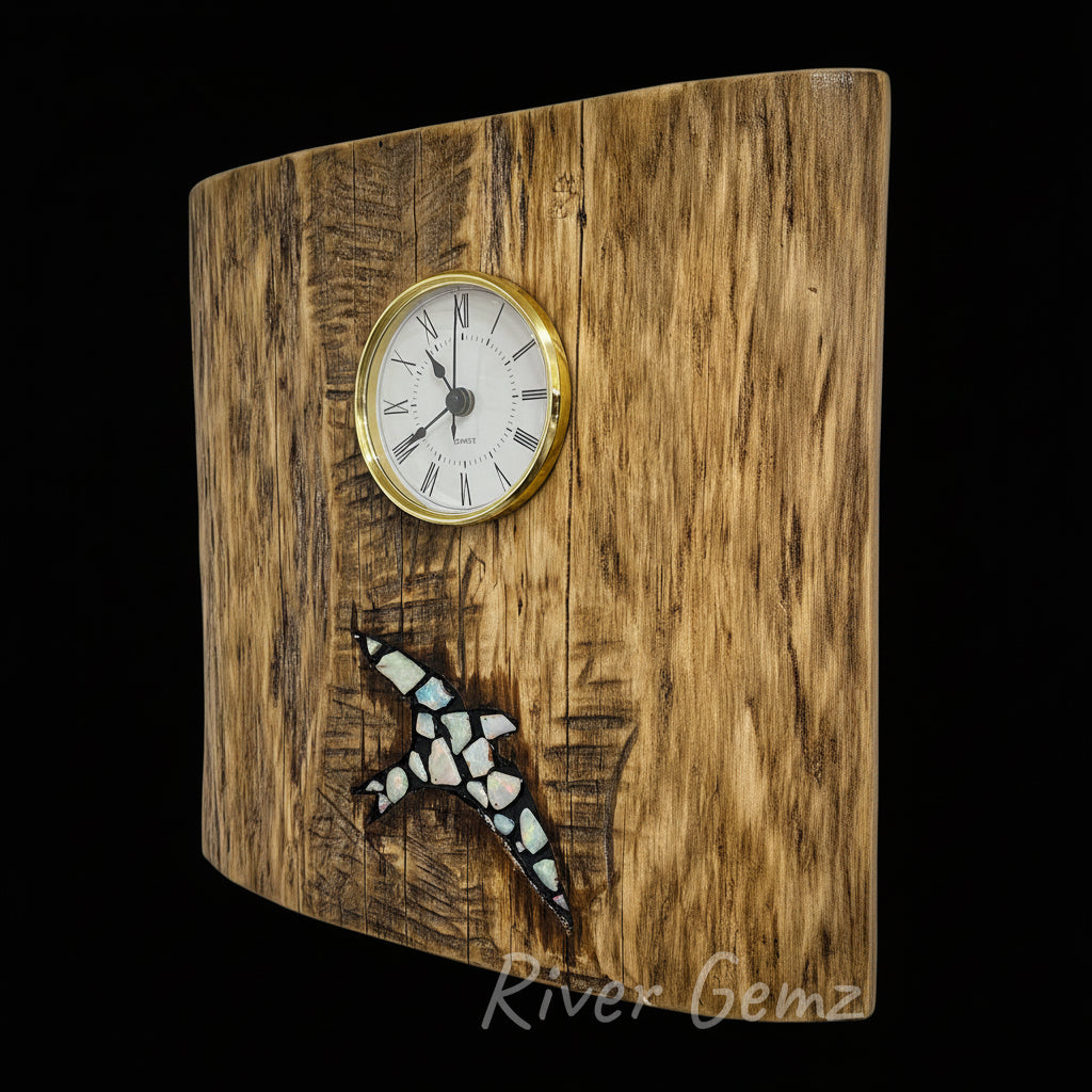 Wooden wall clock with a bird inlaid with white opals, branded 'River Gemz'.