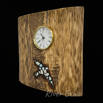 Wooden wall clock with a bird inlaid with white opals, branded 'River Gemz'.