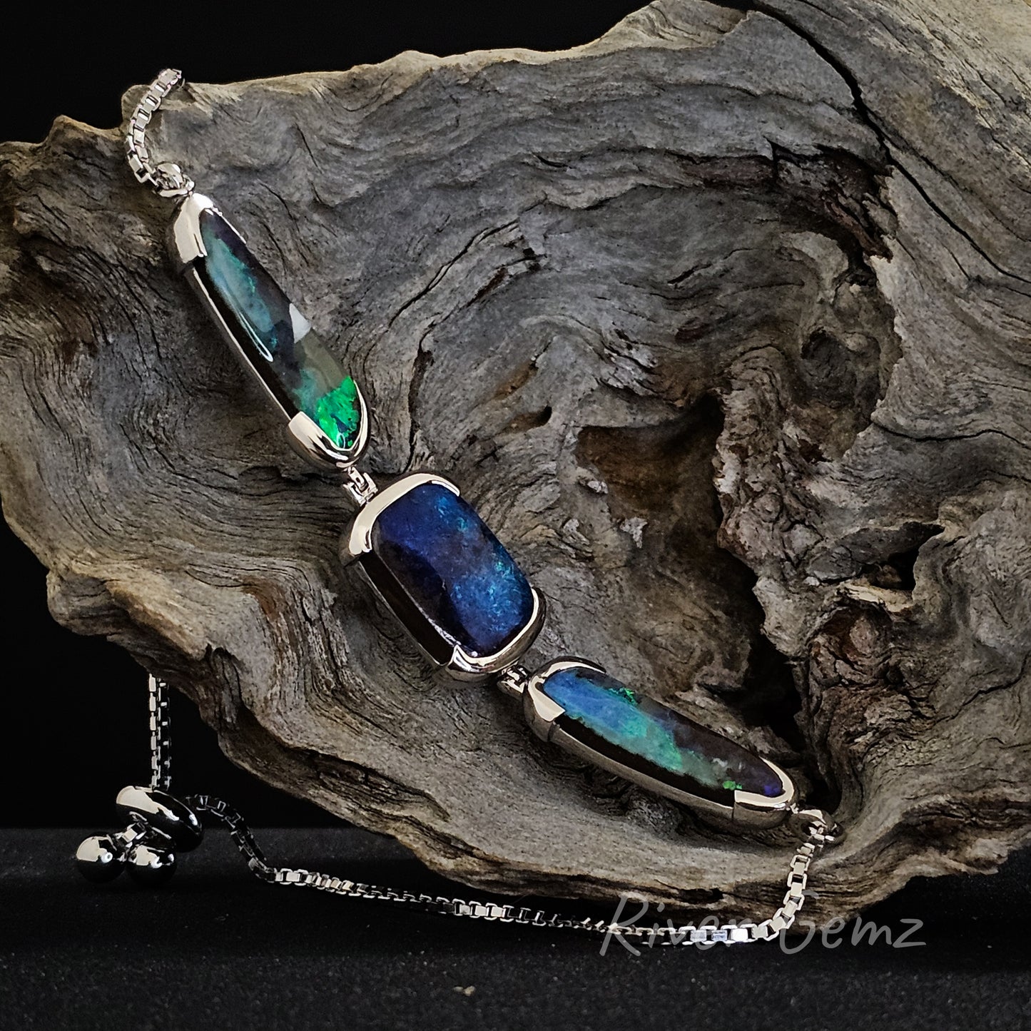 This slightly side on view shows the thickness of each of the 3 boulder opals in the silver bracelet.