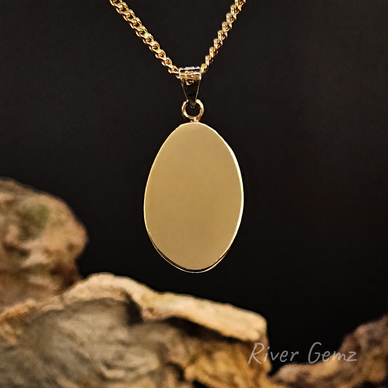 Rear view of the necklace shows the full gold backing behind the white opal on a dark background with 'River Gemz' branding.