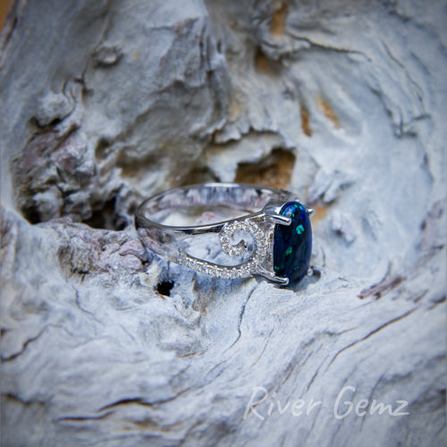 Side view of the ring shows the diamond swirls fully and the thickness of the opal.