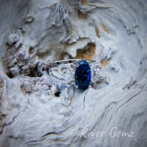 Dark opal is contrasted well by the white gold setting of the ring.