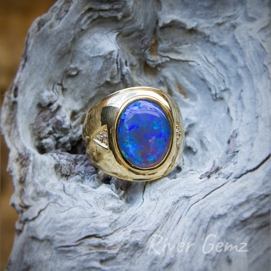 Large oval shaped dark blue opal in yellow gold men's ring with some small diamonds to add class to the dress ring