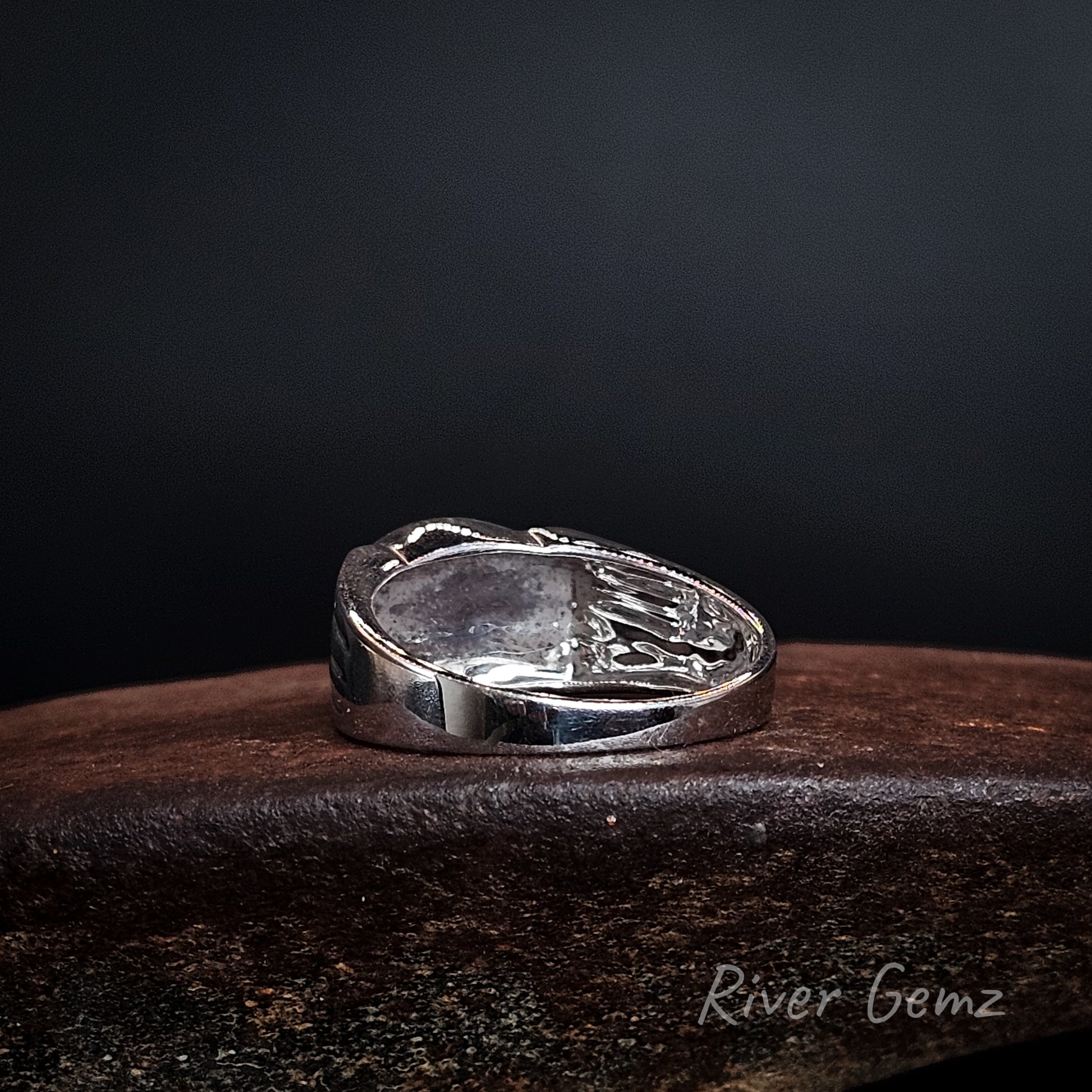 Rear view showing the solid silver backing used to secure the opal in the sterling silver ring.