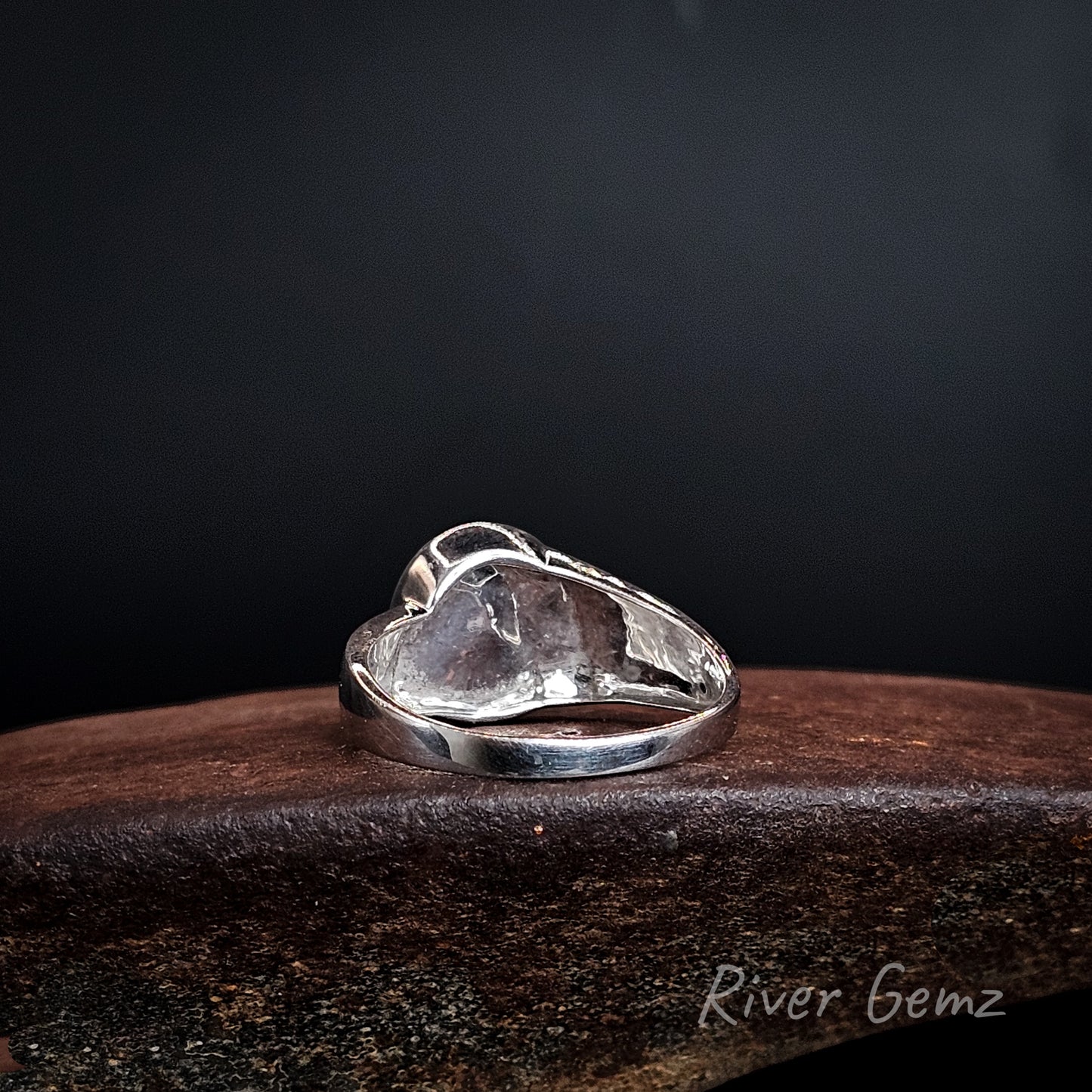 Back of ring shows the solid silver behind the opal set in it.