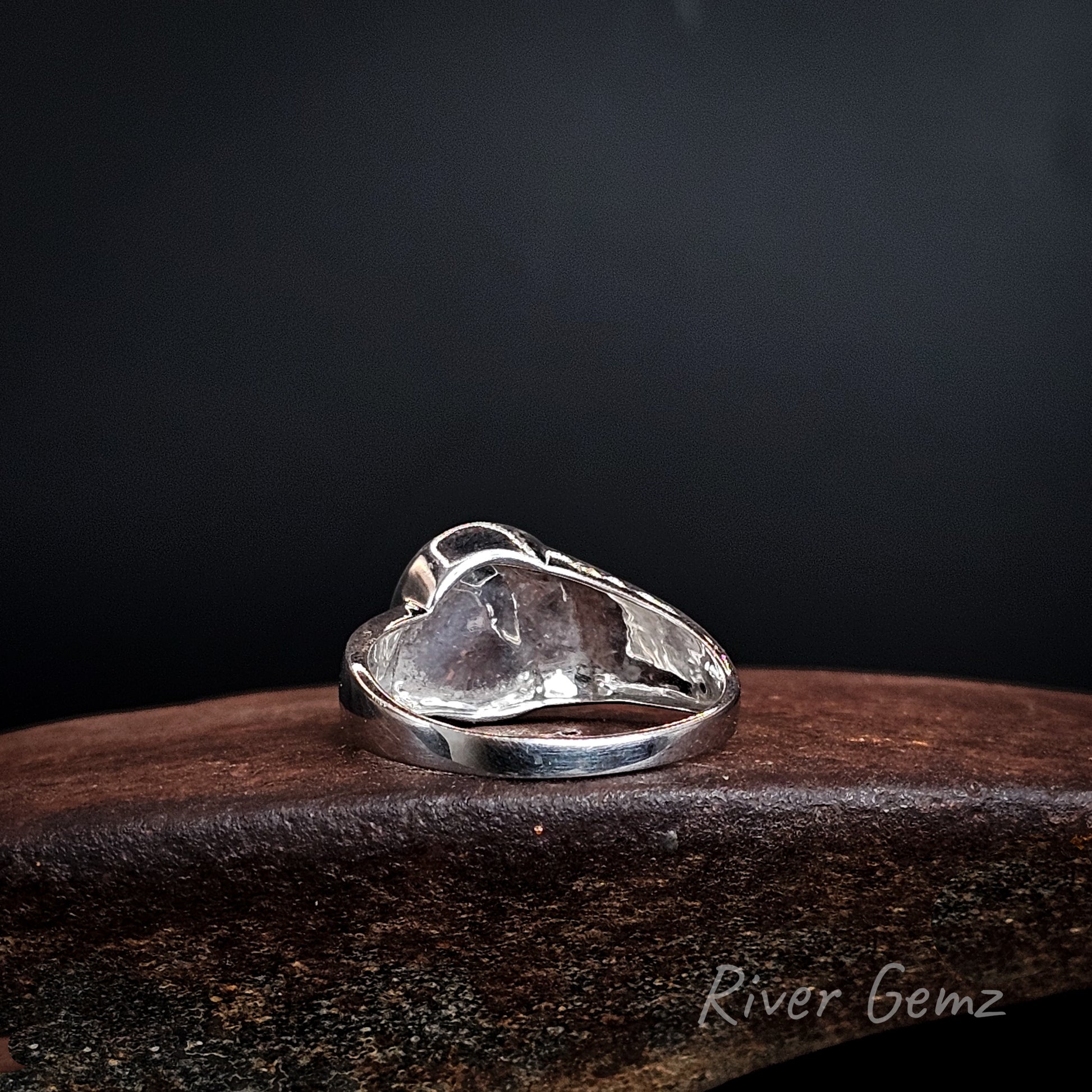 Back of ring shows the solid silver behind the opal set in it.