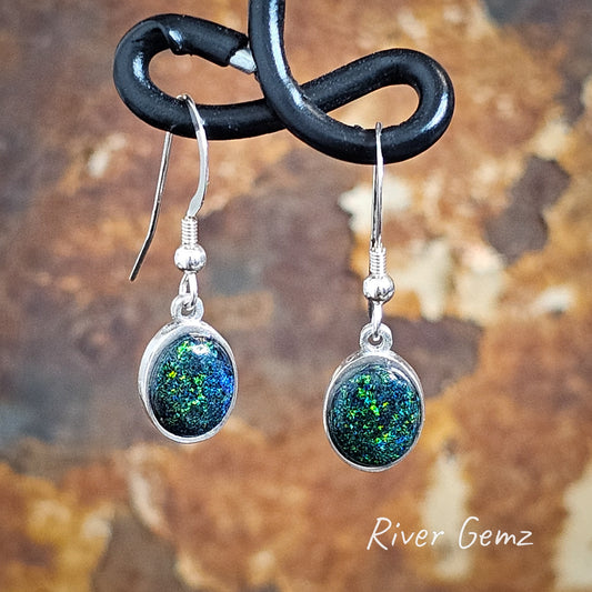 Dark blue and green oval shaped opals in silver shepherd hook earrings.