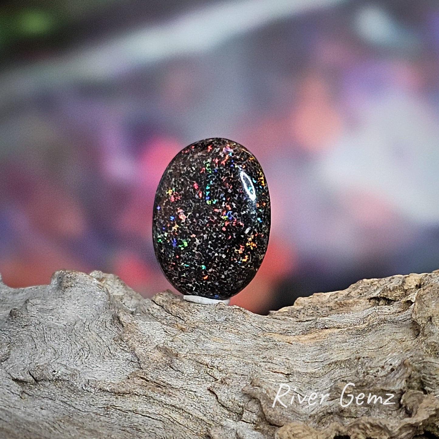 Speckled colours on a dark brown base in this unset oval shaped matrix opal.