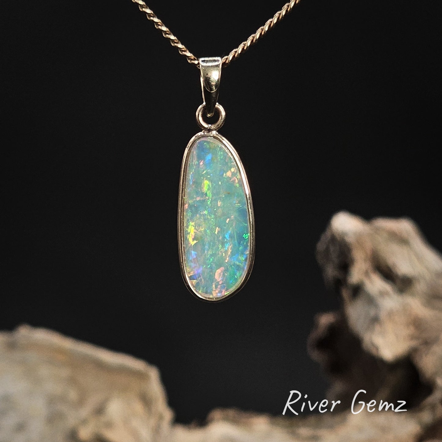 Rear view of the opal pendant shows the colour is on both sides of the stone.