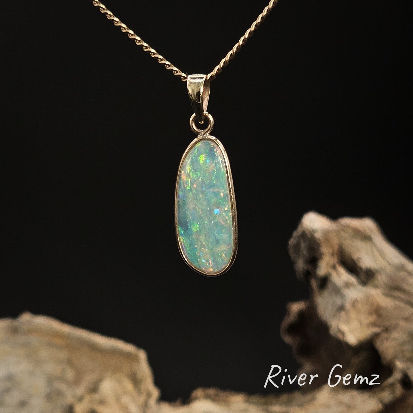Opal pendant necklace on a dark background with 'River Gemz' branding.