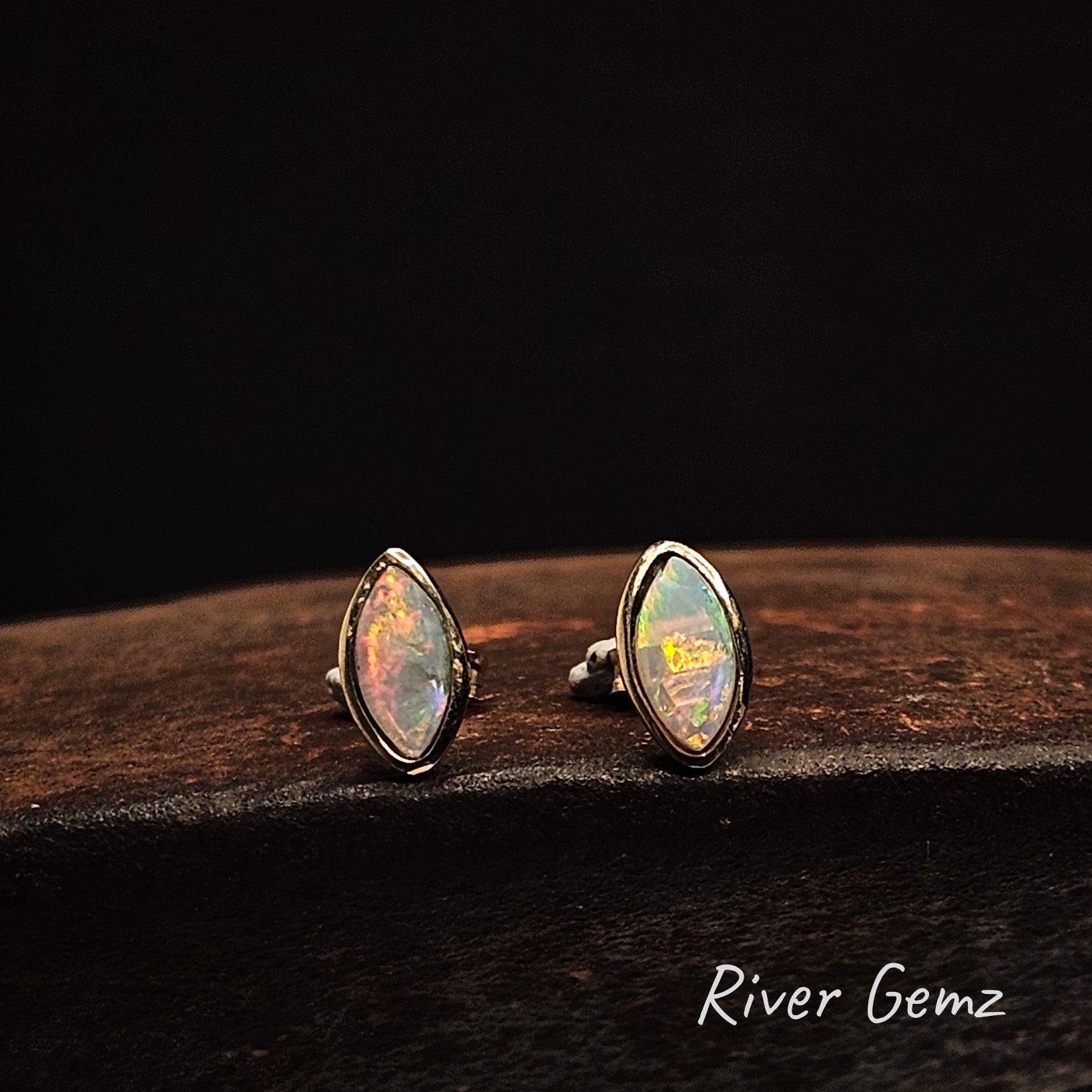 Colourful marquis shaped crystal opals besel set in yellow gold earrings.