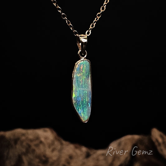 Opal pendant necklace on a dark background with 'River Gemz' branding.