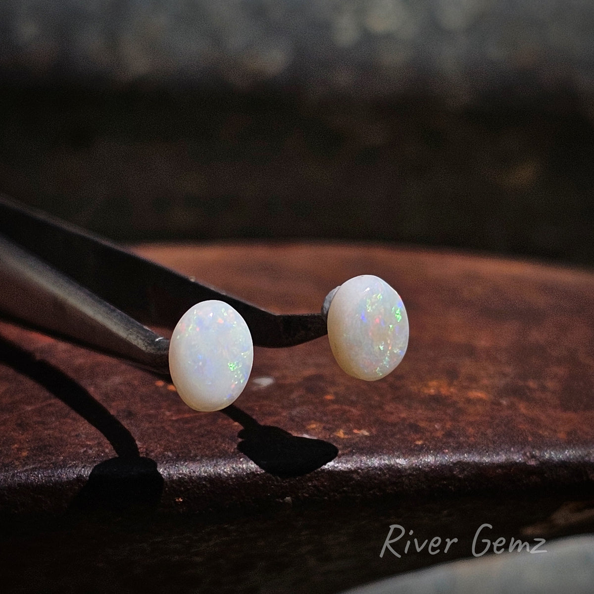 Oval shaped light opals with small specks of colours.