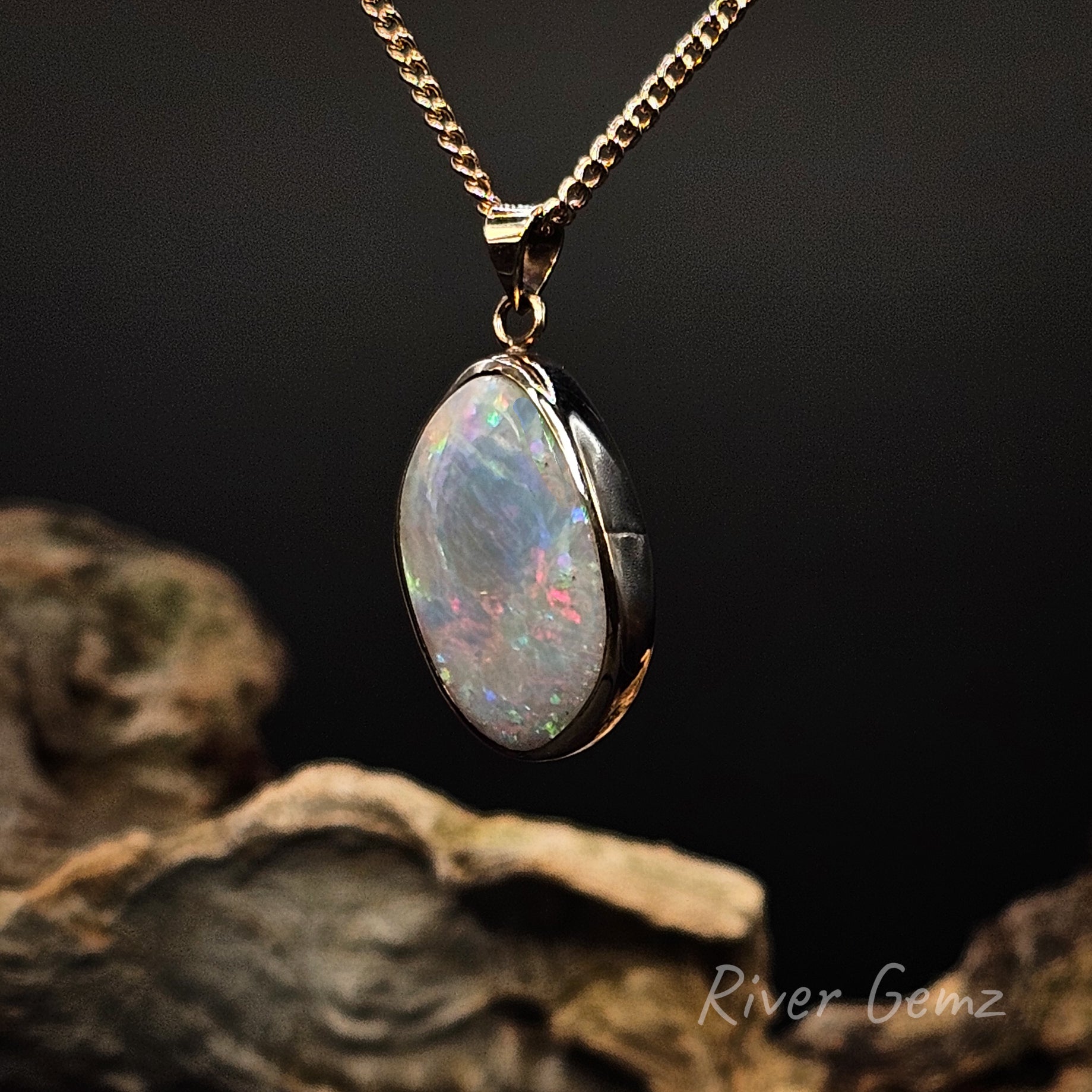 Opal pendant necklace on a dark background with 'River Gemz' branding.