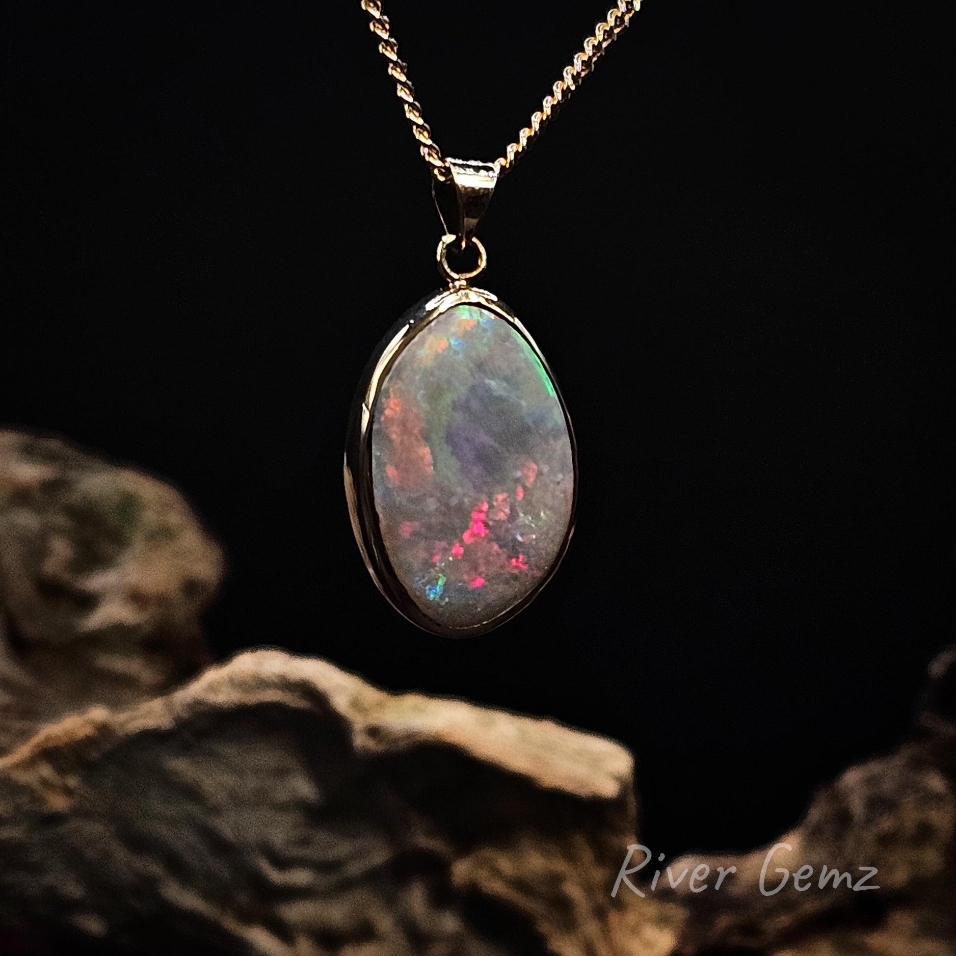 Opal pendant necklace on a dark background with 'River Gemz' branding.