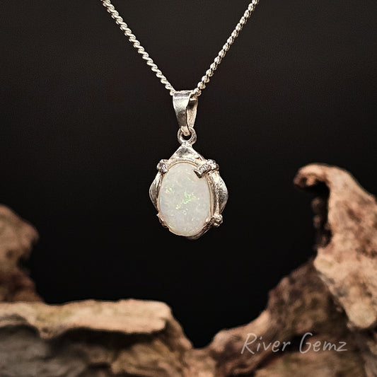 Opal pendant necklace on a dark background with 'River Gemz' branding.