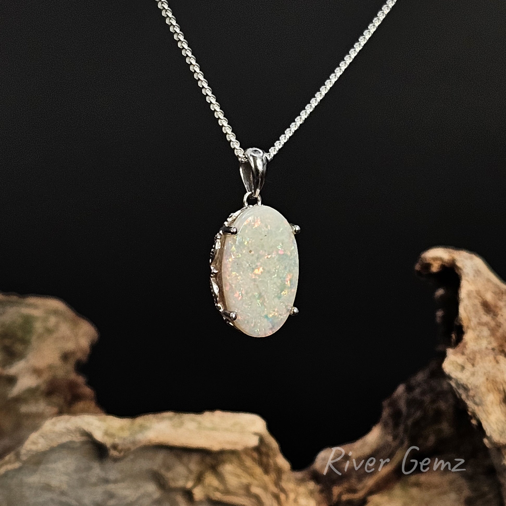 Necklace with an oval shaped light opal on a dark background
