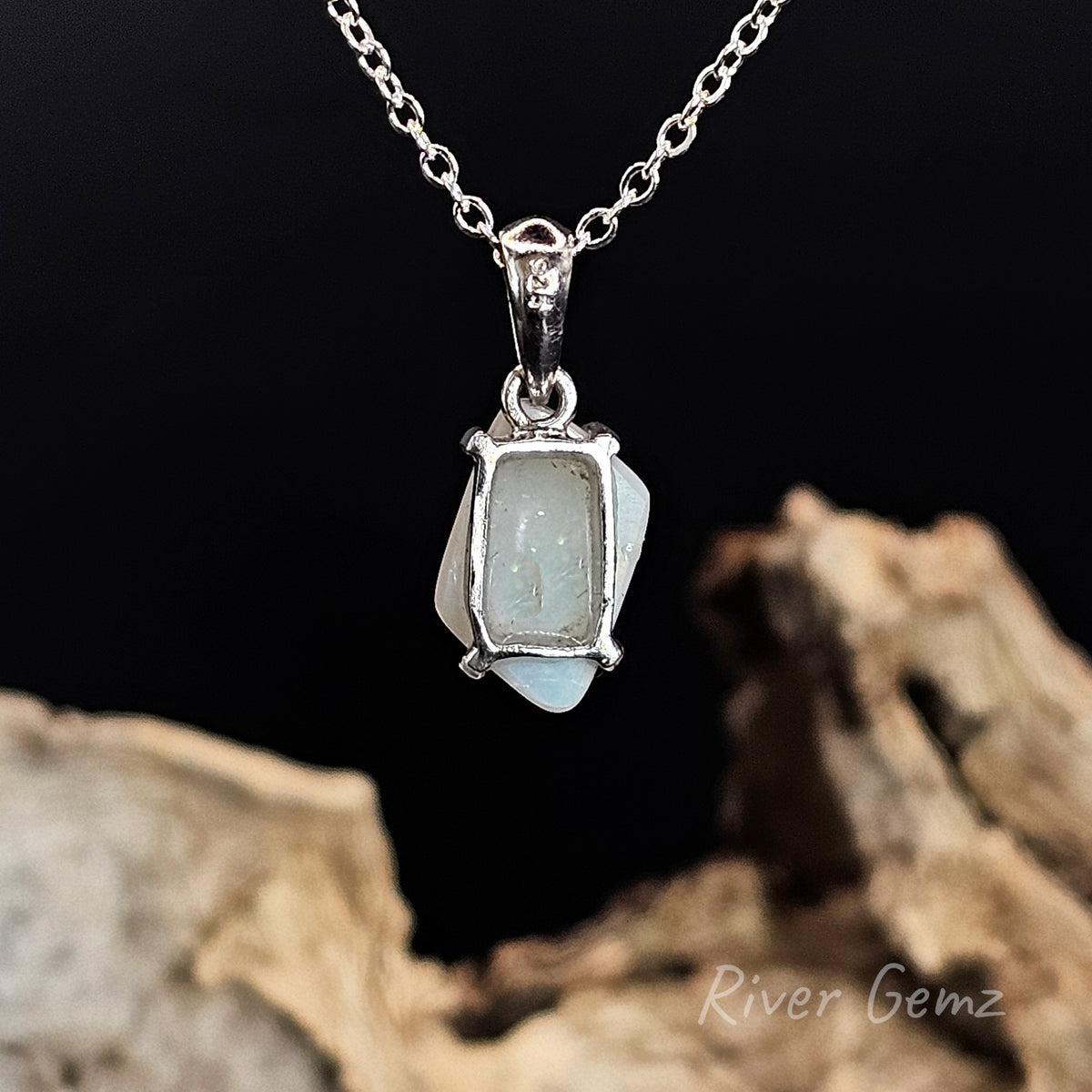 Rear view of the necklace shows the light base tone of the white opal set in it.