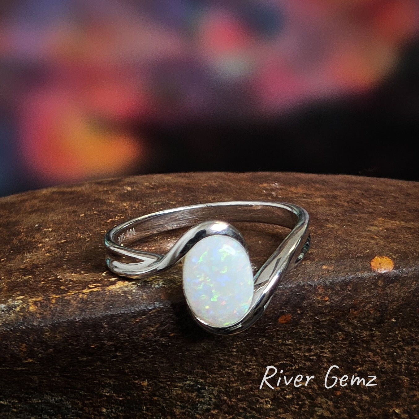 Oval shaped light opal elegantly set in a silver ring.