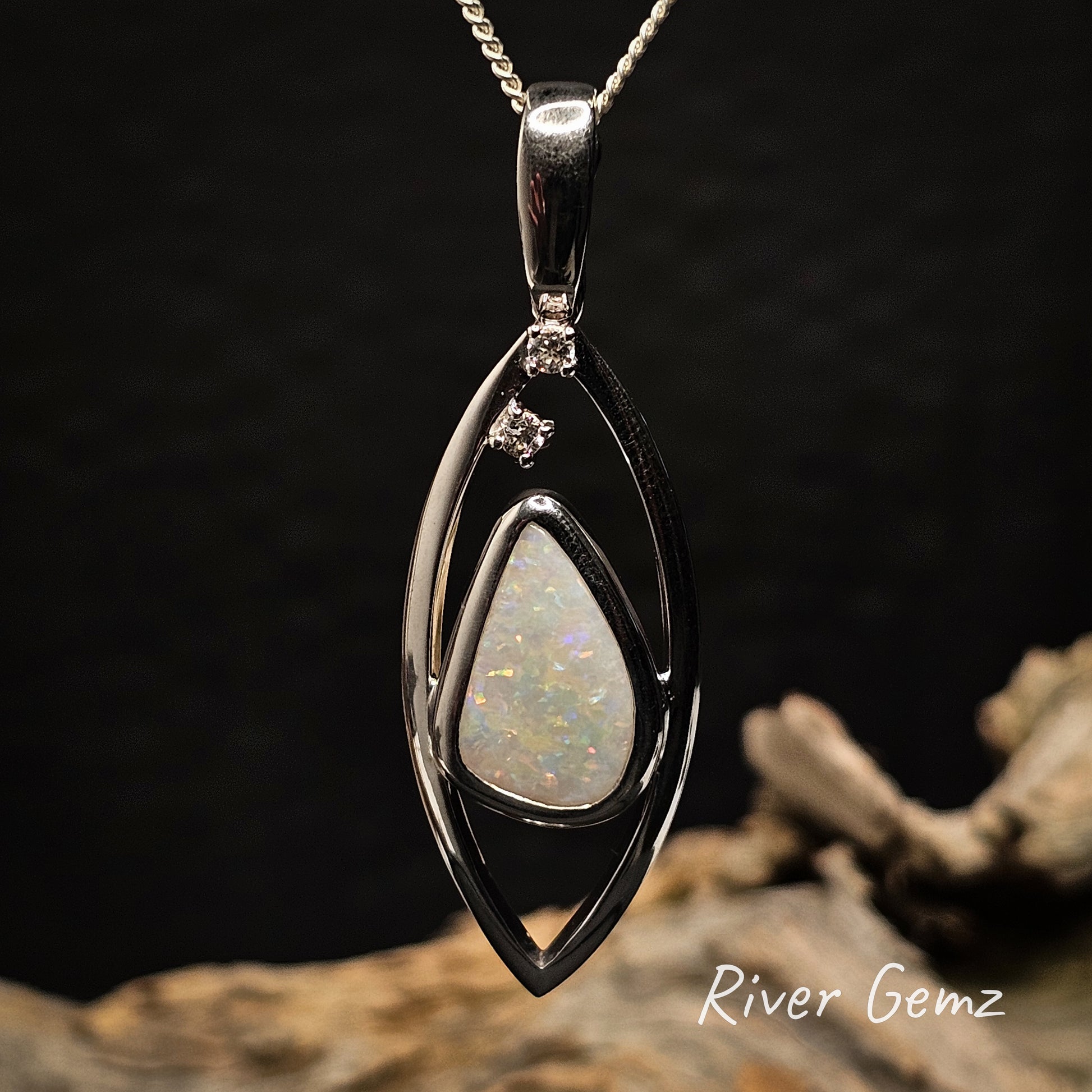 Multi-coloured white opal besel set in silver pendant.