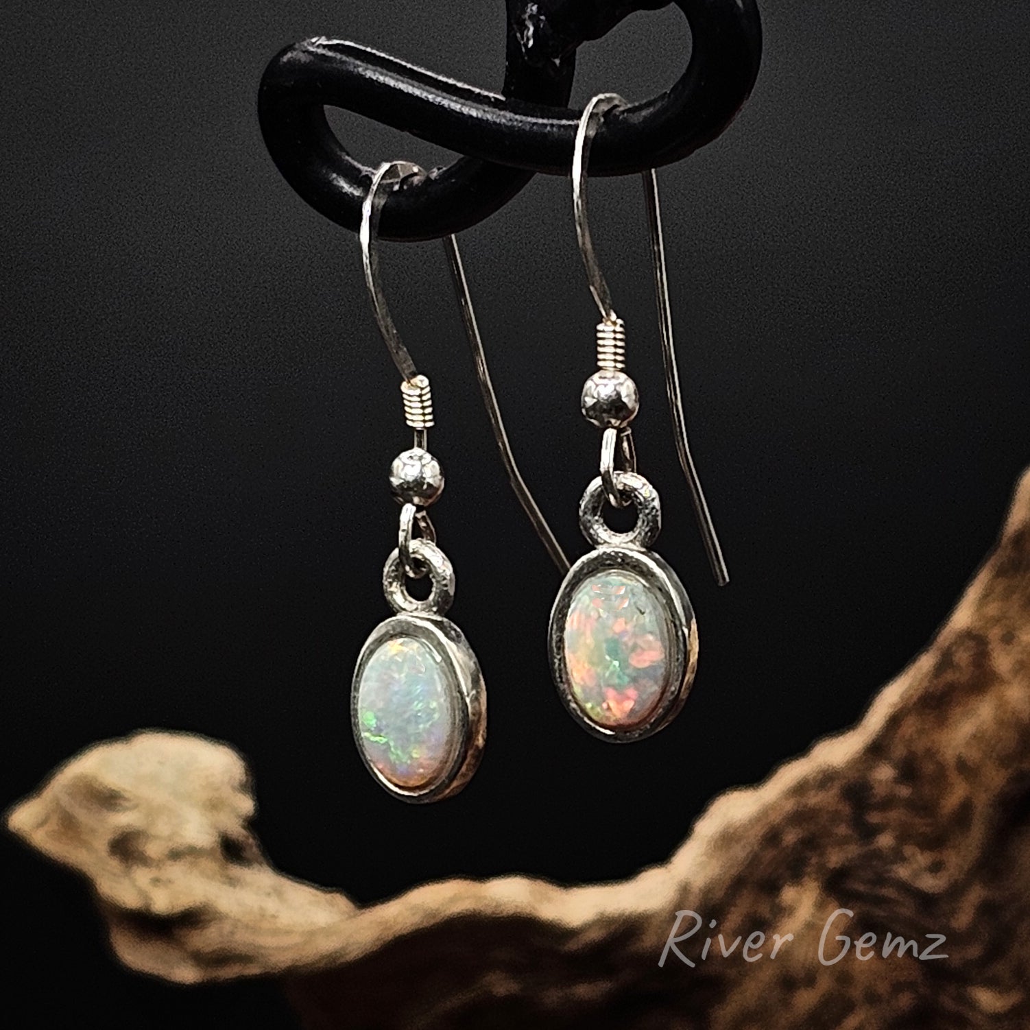 Light opals set in sterling silver dangly earrings.