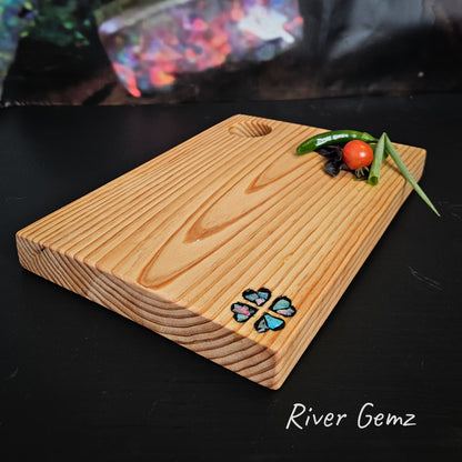 Pine cheeseboard with an opal mosaic of four love hearts  in a spiral pattern.