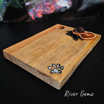 Opal pieces inlaid into a paw print features in the pine cheeseboard.