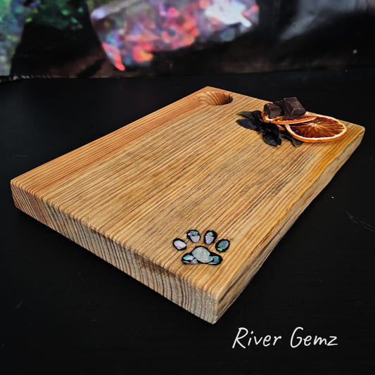 Opal pieces inlaid into a paw print features in the pine cheeseboard.