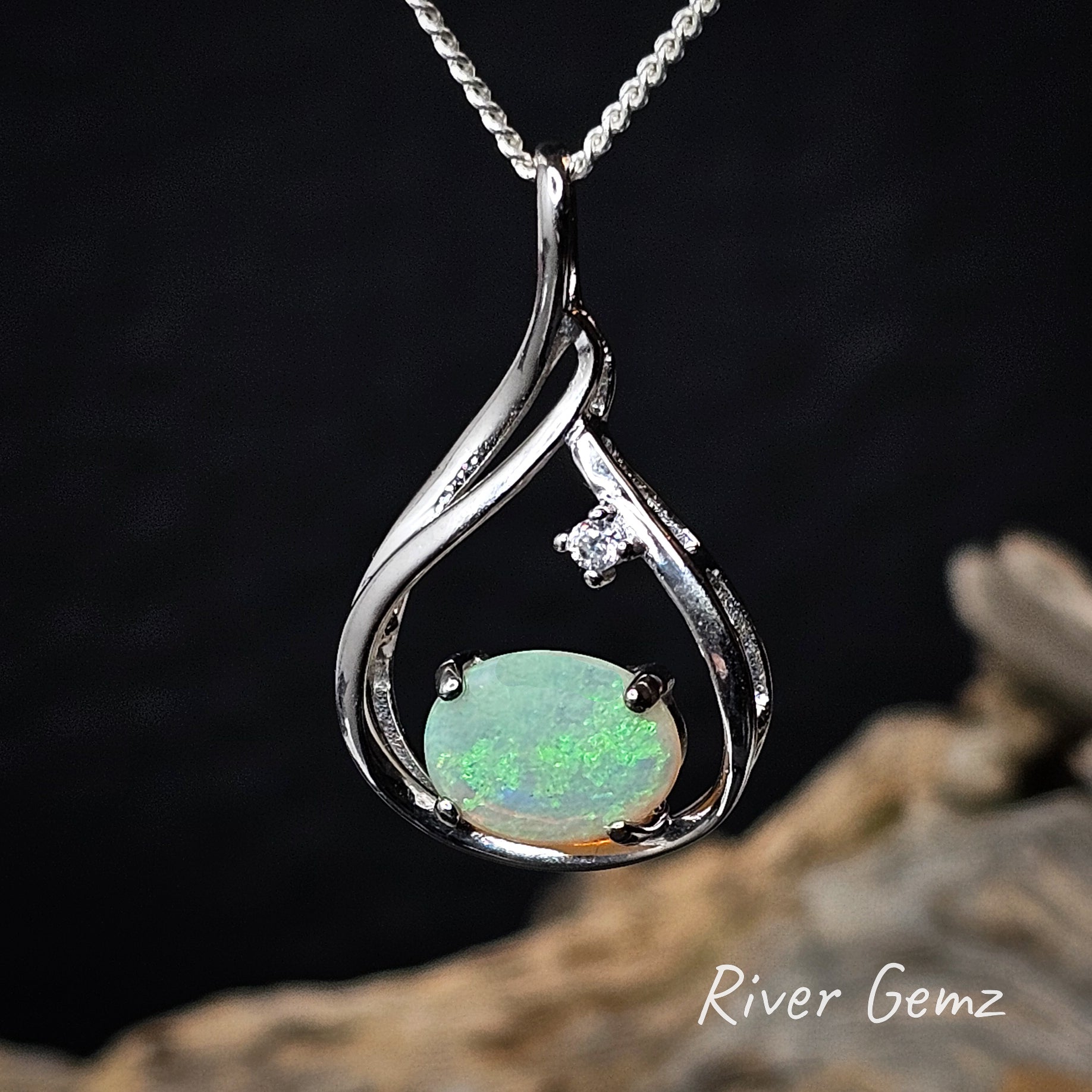 Oval shaped green opal set East-West in a sterling silver necklace.