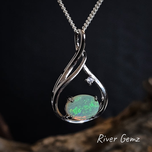 Oval shaped green crystal opal with white topaz stone in silver necklace.