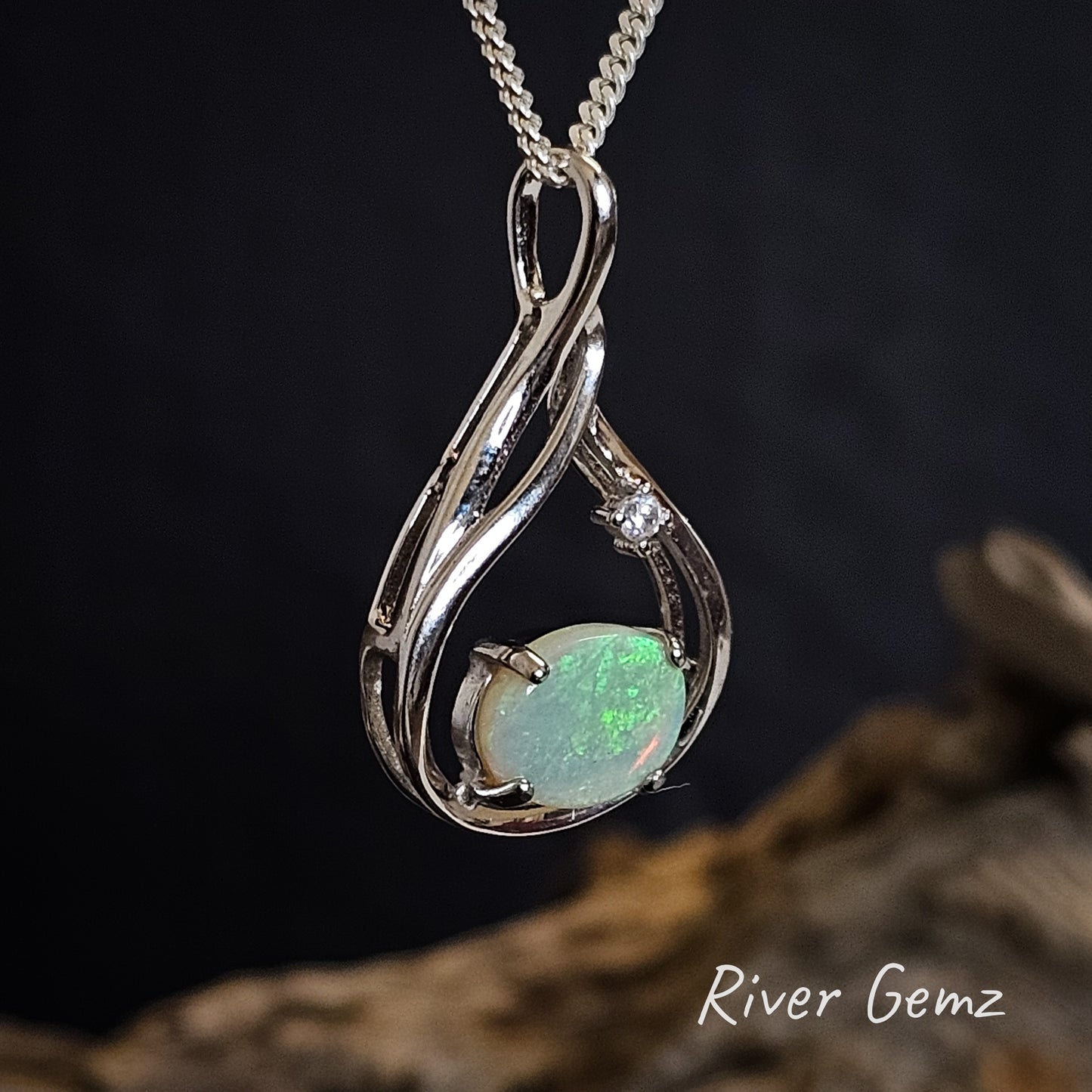 Light crystal opal in silver pendant with hidden bail.