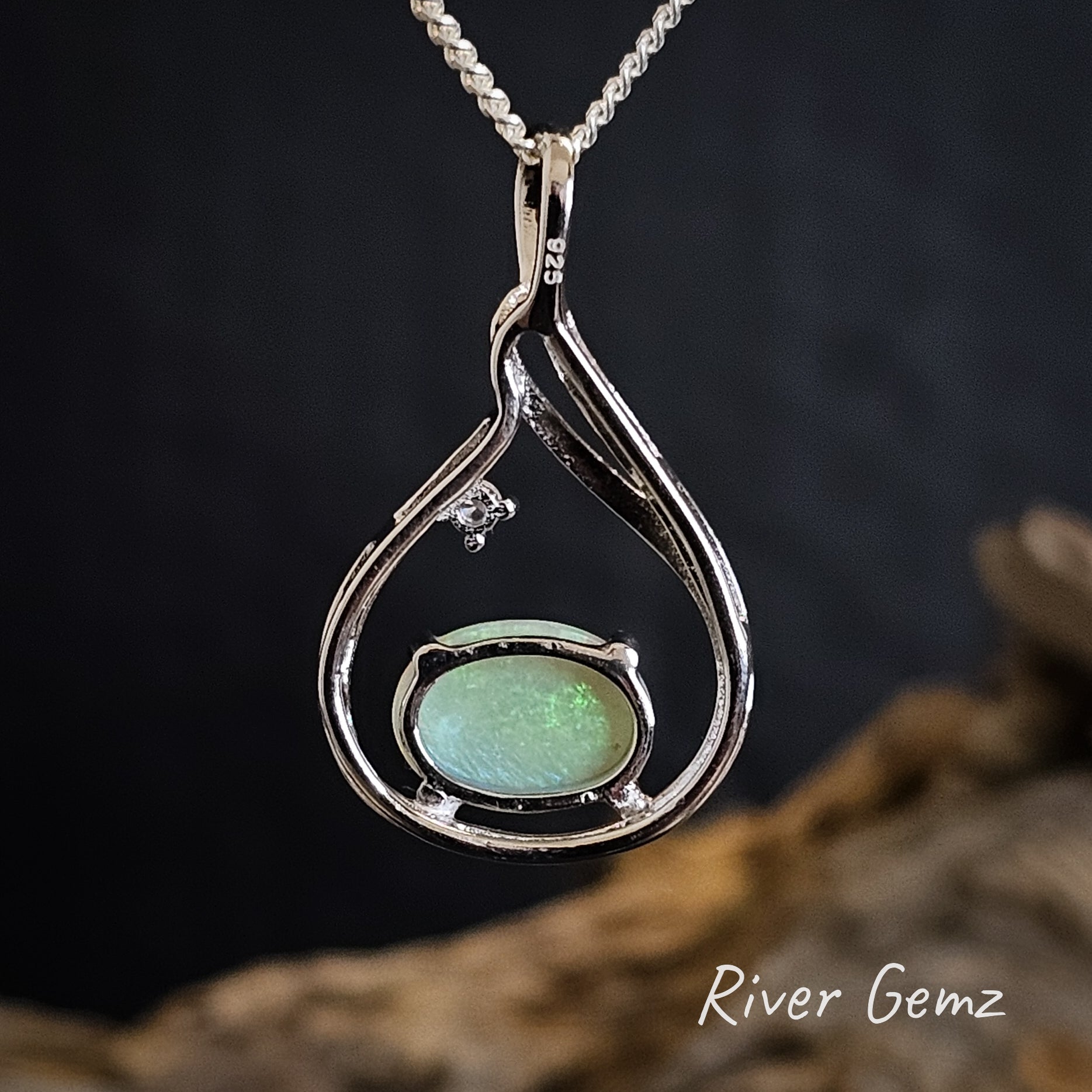 Rear view of the pendant shows the light base tone of the crystal opal and the 925 stamp to indicate sterling silver.