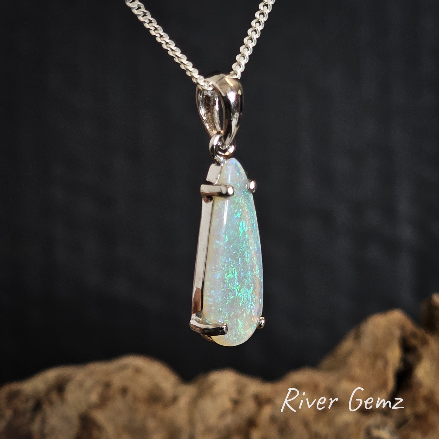 Light green crystal opal silver pendant on a chain with a dark background and 'River Gemz' branding.